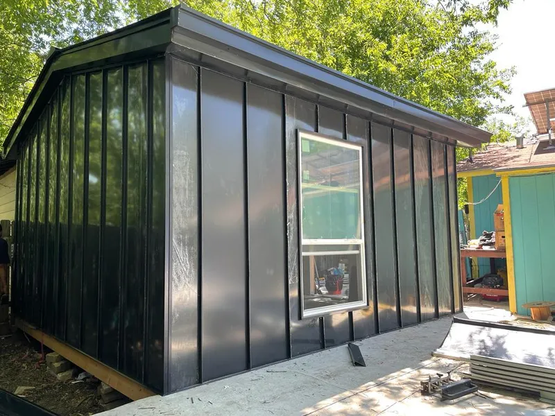 Black standing seam metal wall panels for Roof Inspection in Broussard