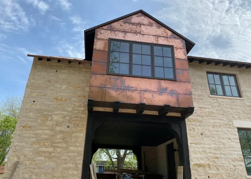 Copper metal panel facade on a stone building for Skylight Installation in Broussard