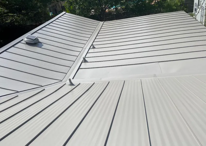 Solar attic fan installed on a metal roof for Roof Ventilation in Broussard